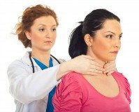 doctor checking woman for low thyroid function symptoms